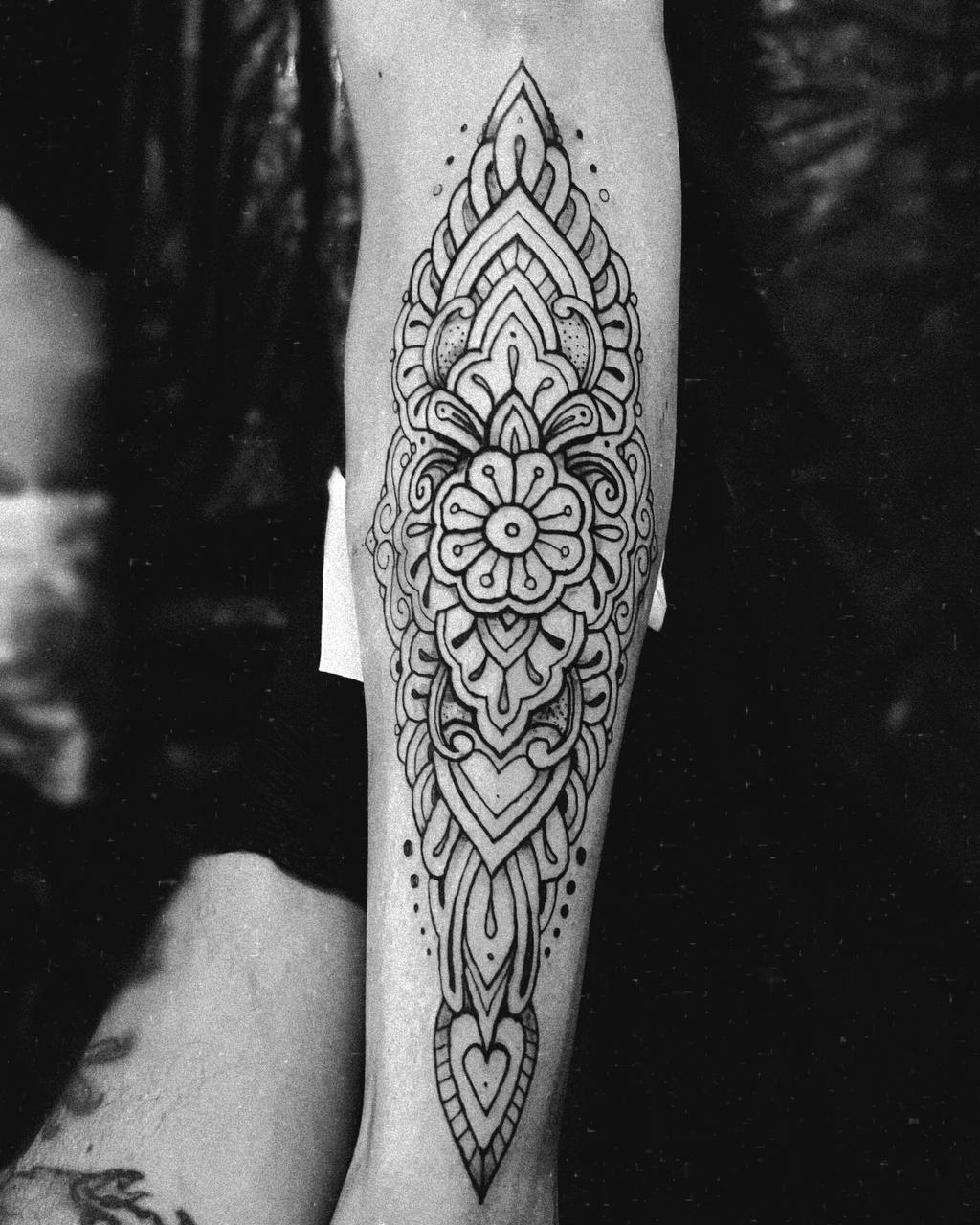 Ornamental floral forearm tattoo