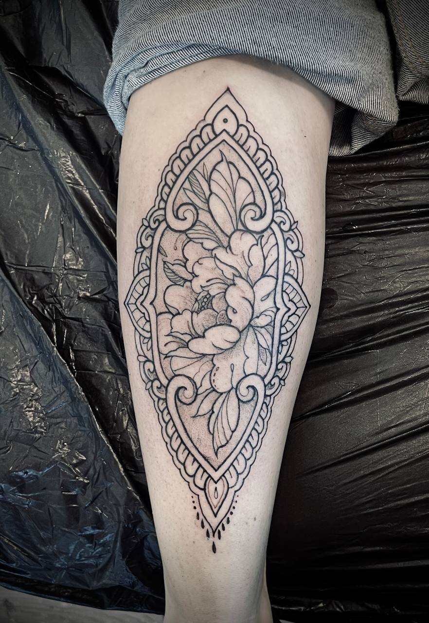 Ornamental floral leg tattoo